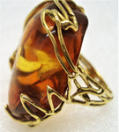 Natural amber set in a stunning 18-karat gold ring left side